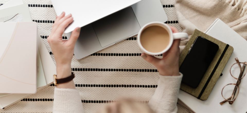 women with laptop and cup of coffee